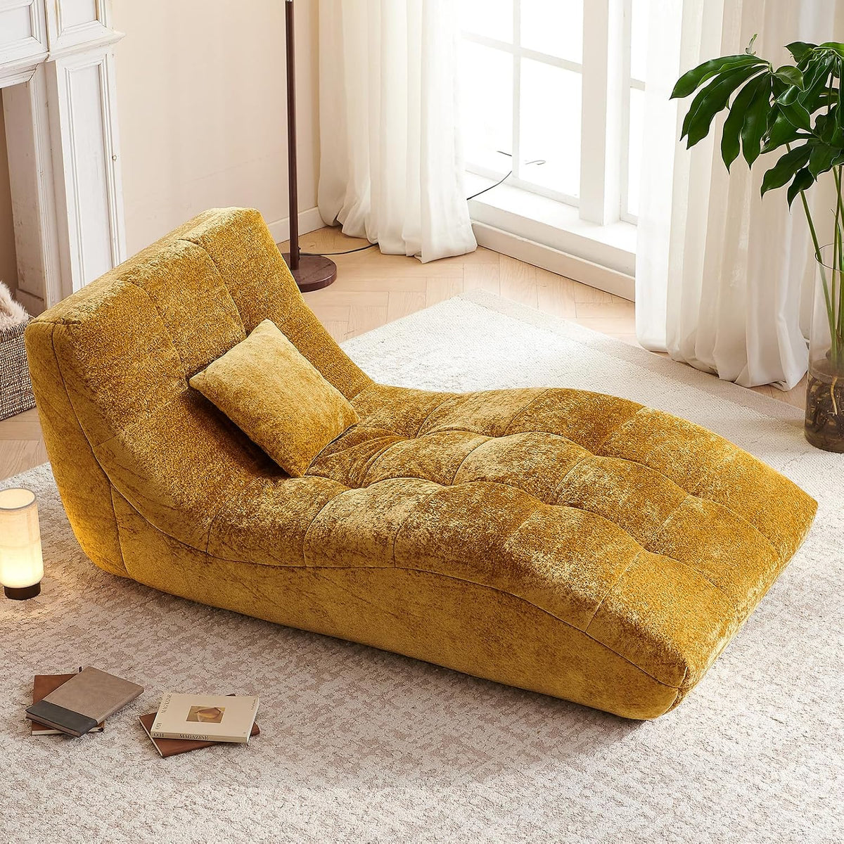 Same curved tufted chaise in a bright mustard yellow fabric styling a sunny corner with a small pillow.