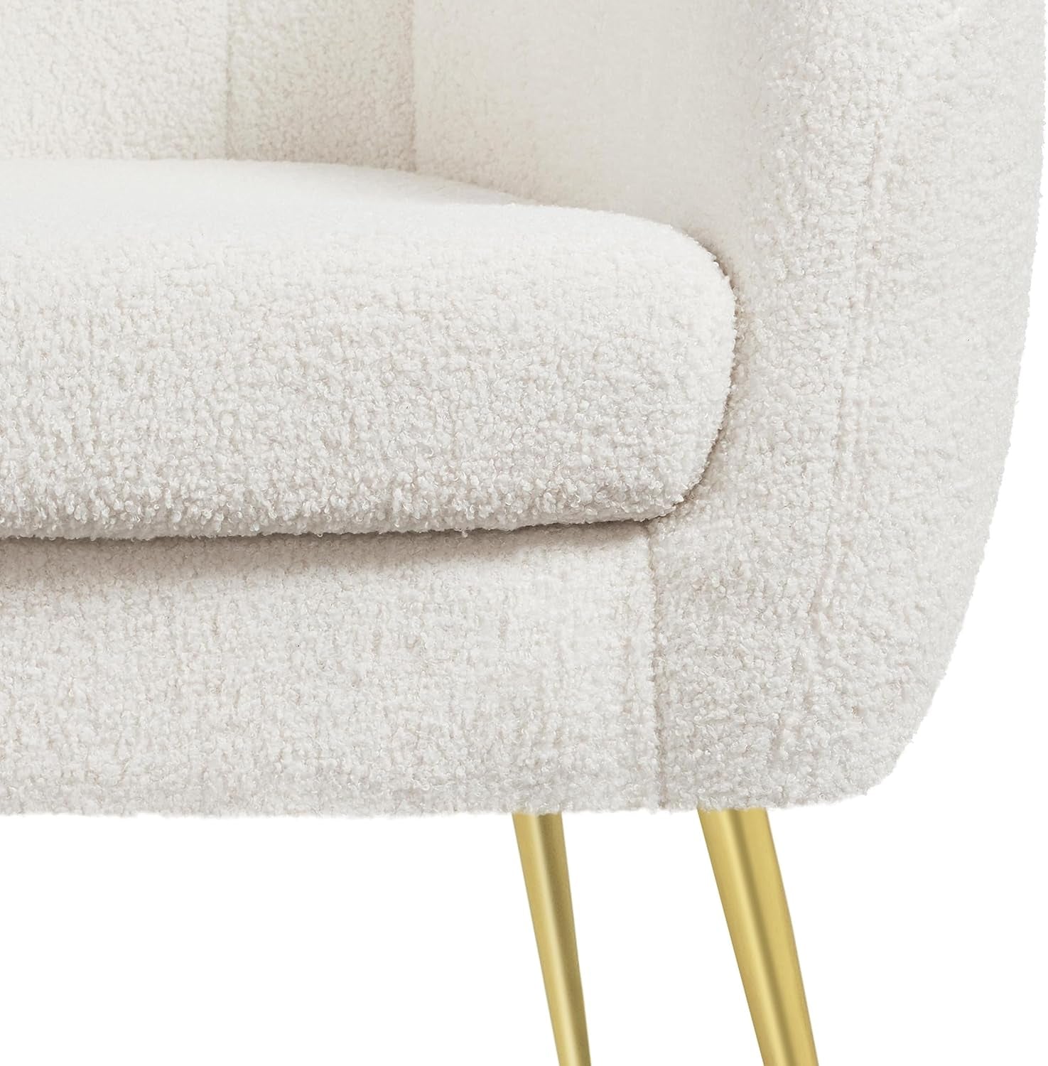 Close detail of the removable seat cushion, bouclé upholstery and gold metal leg