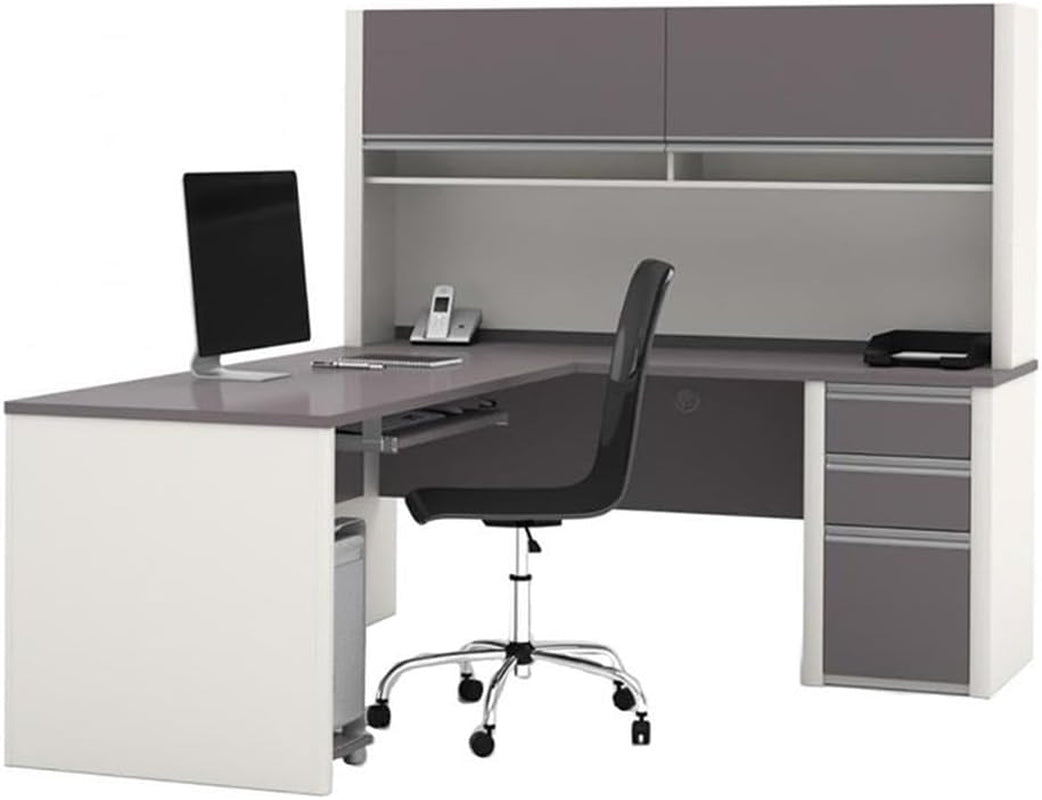 Sandstone and slate-gray L-shaped office desk with hutch, angled front-left view showing keyboard shelf and pedestal