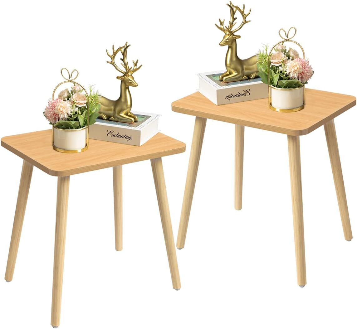 Two light wood square side tables with rounded corners, each topped with a decorative vase and book