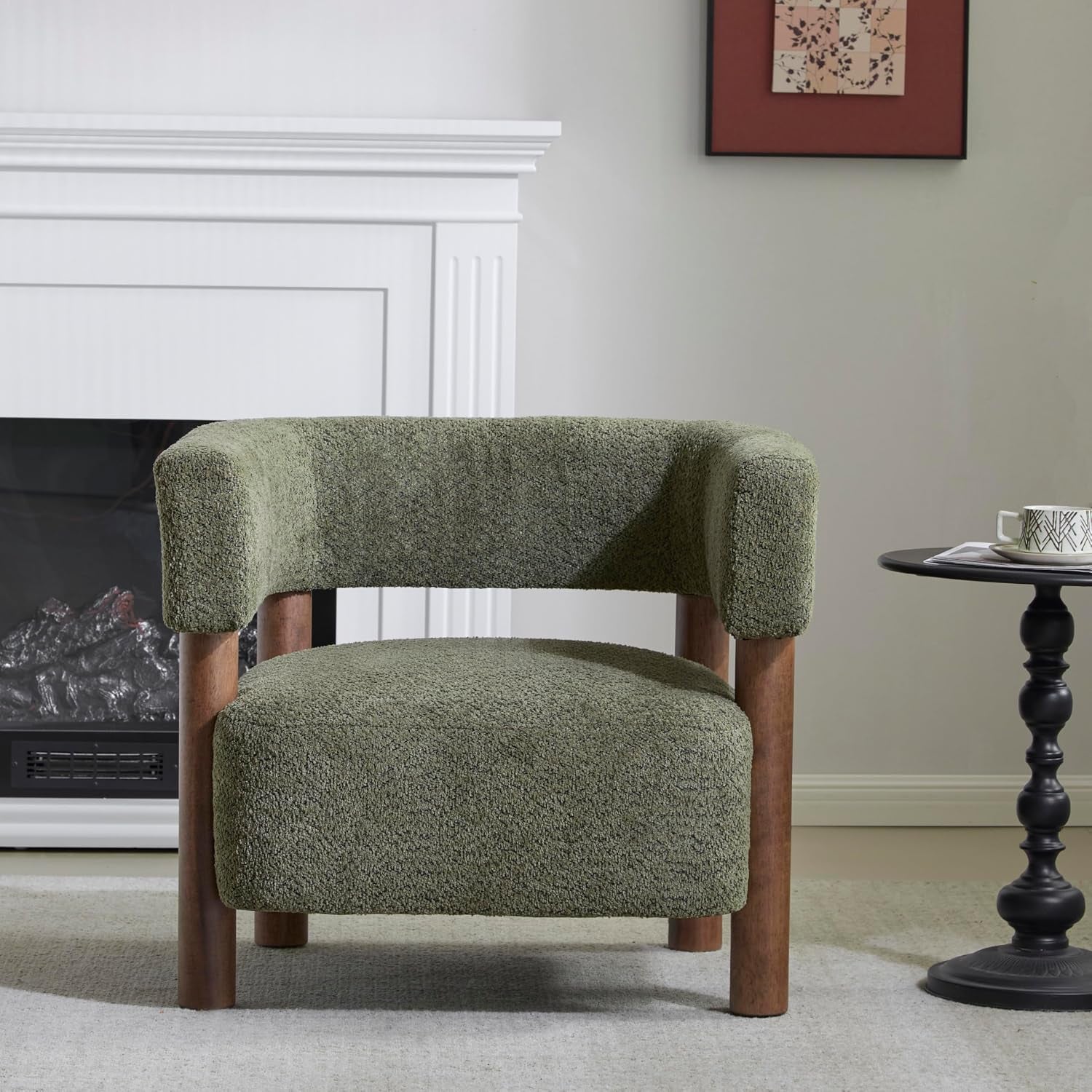 Low-profile boucle accent chair in olive green with rounded back and wooden legs in a living room
