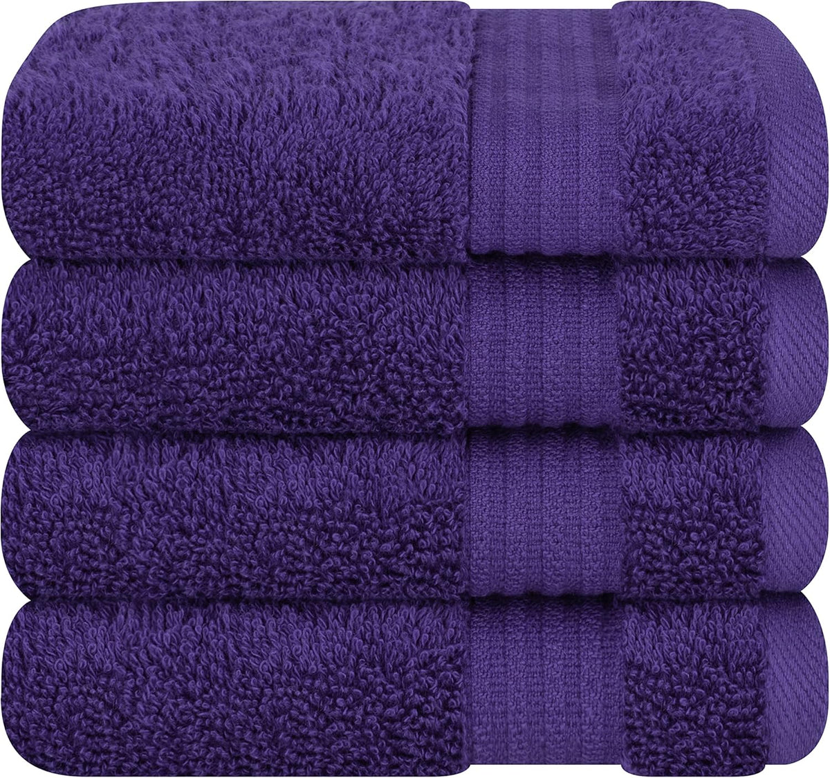 Close-up of four deep purple folded terry towels stacked horizontally