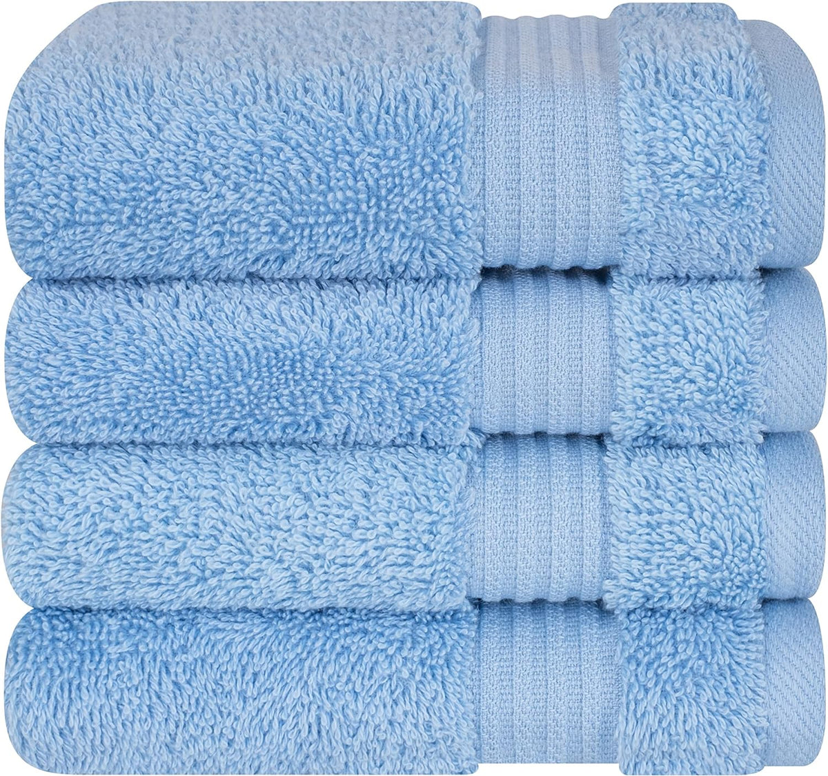 Four neatly stacked light blue towels showing looped terry texture and decorative band