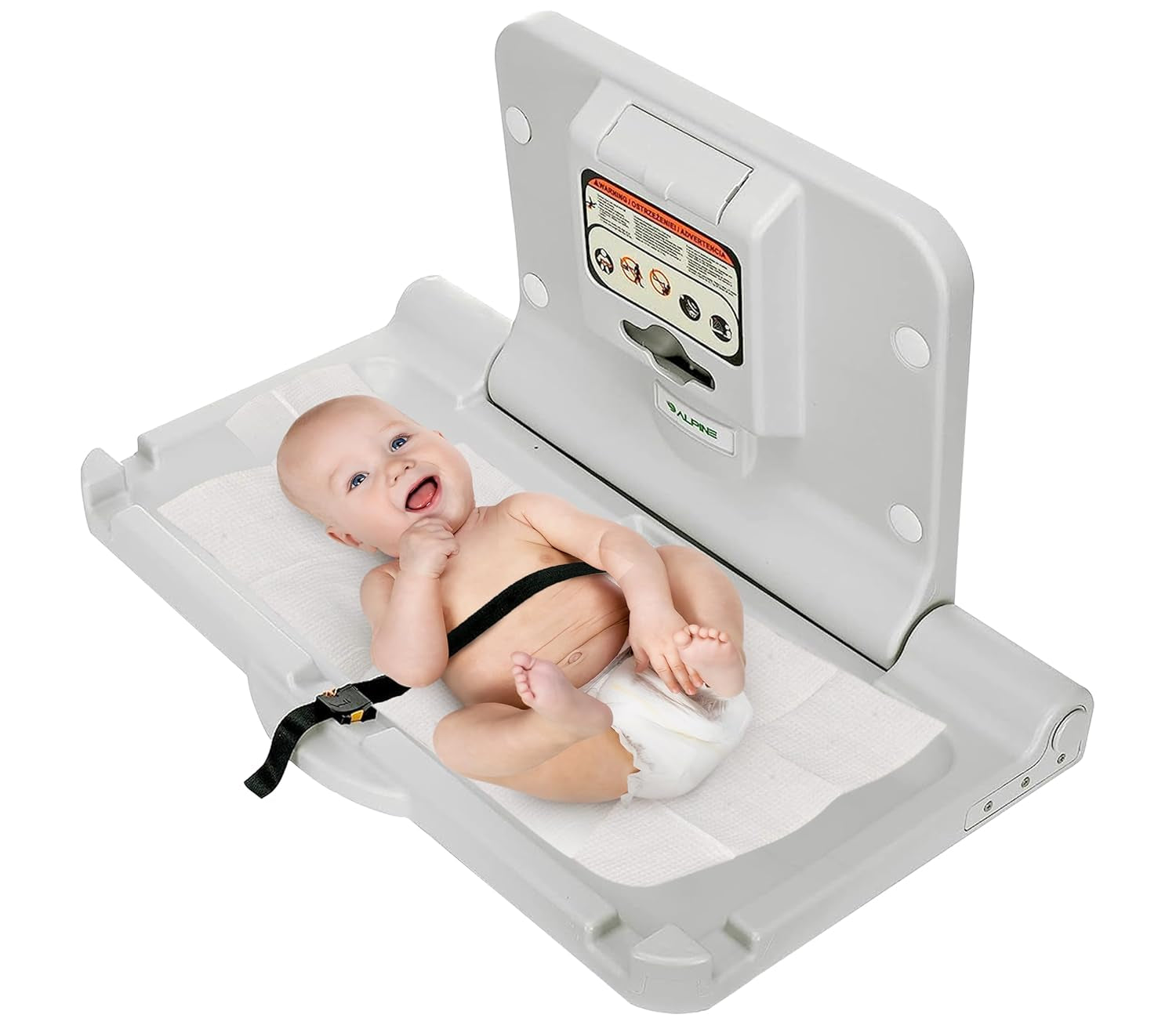 Open wall-mounted baby changing station with a baby lying on a pad secured by a black safety strap.