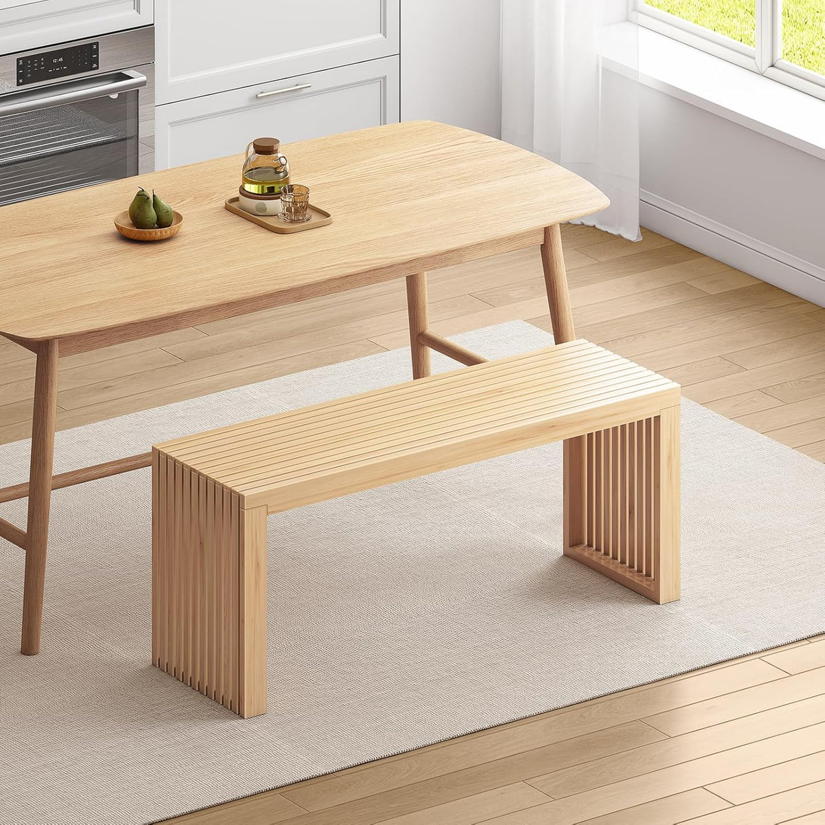 Natural bamboo slatted bench placed beside a dining table on a light rug in a kitchen scene