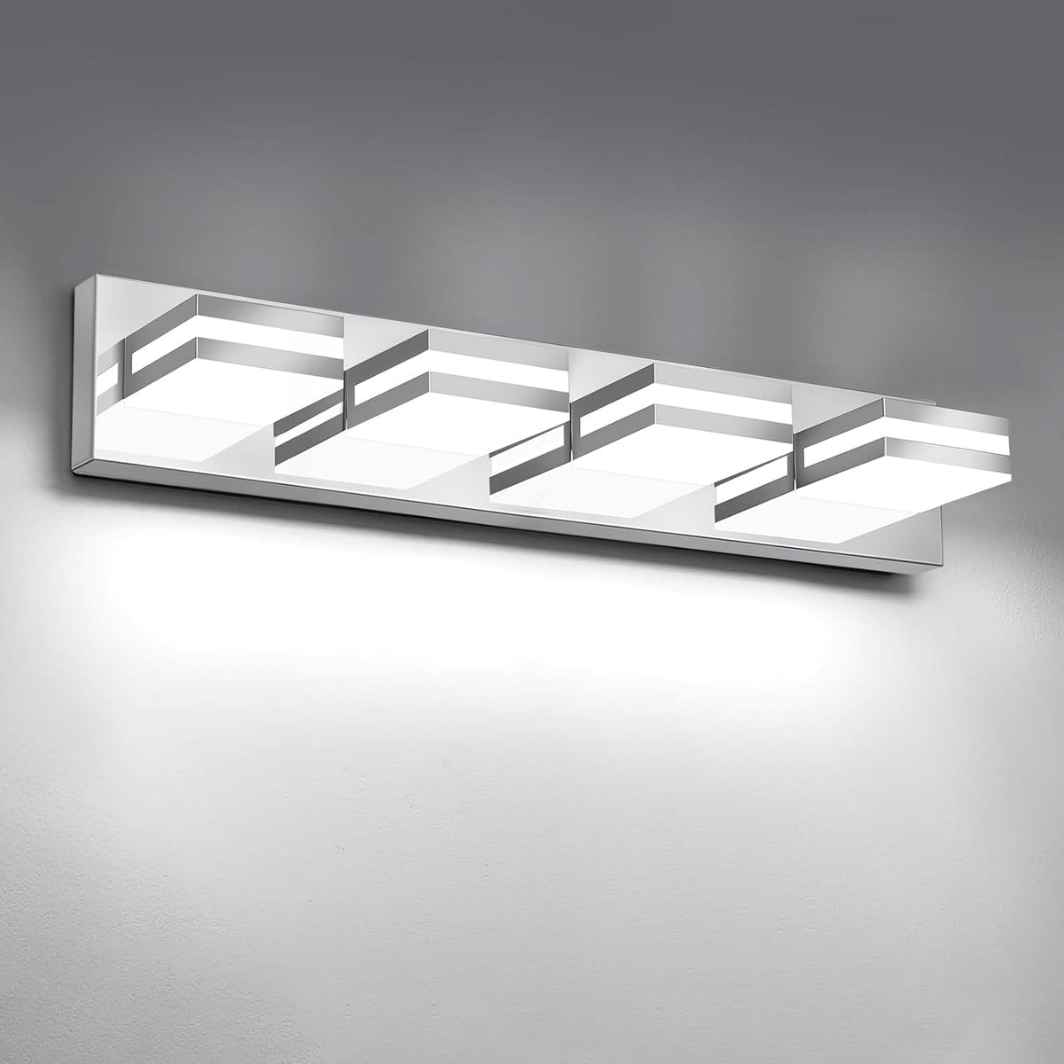 Front-facing view of a long four-light LED vanity bar with mirrored silver accents mounted on a wall.