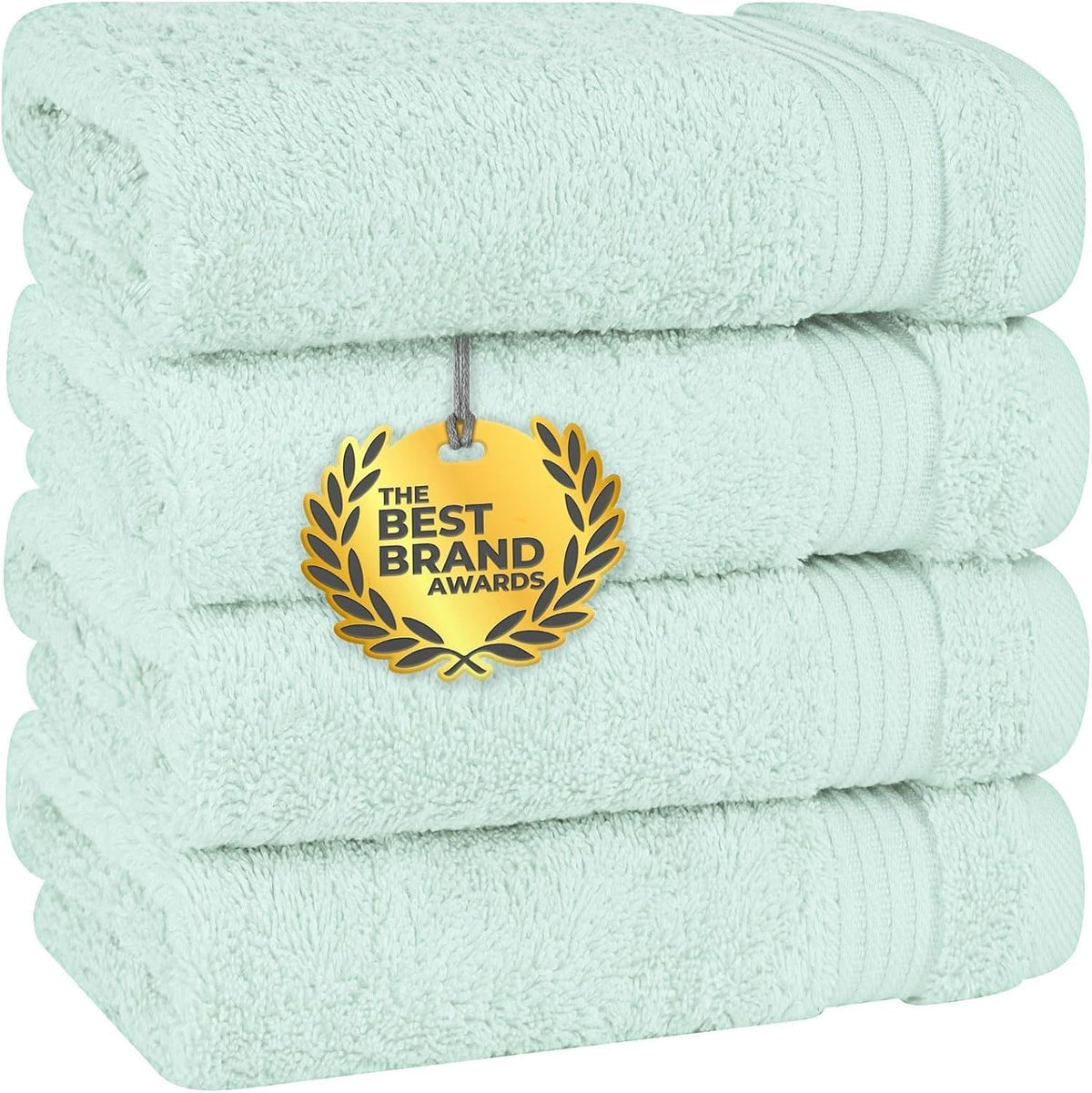 Stack of light mint green towels shown from the side with a gold award medallion tag.