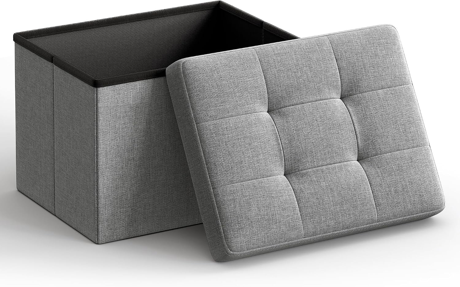 Open light gray fabric storage ottoman with tufted lid propped against the interior