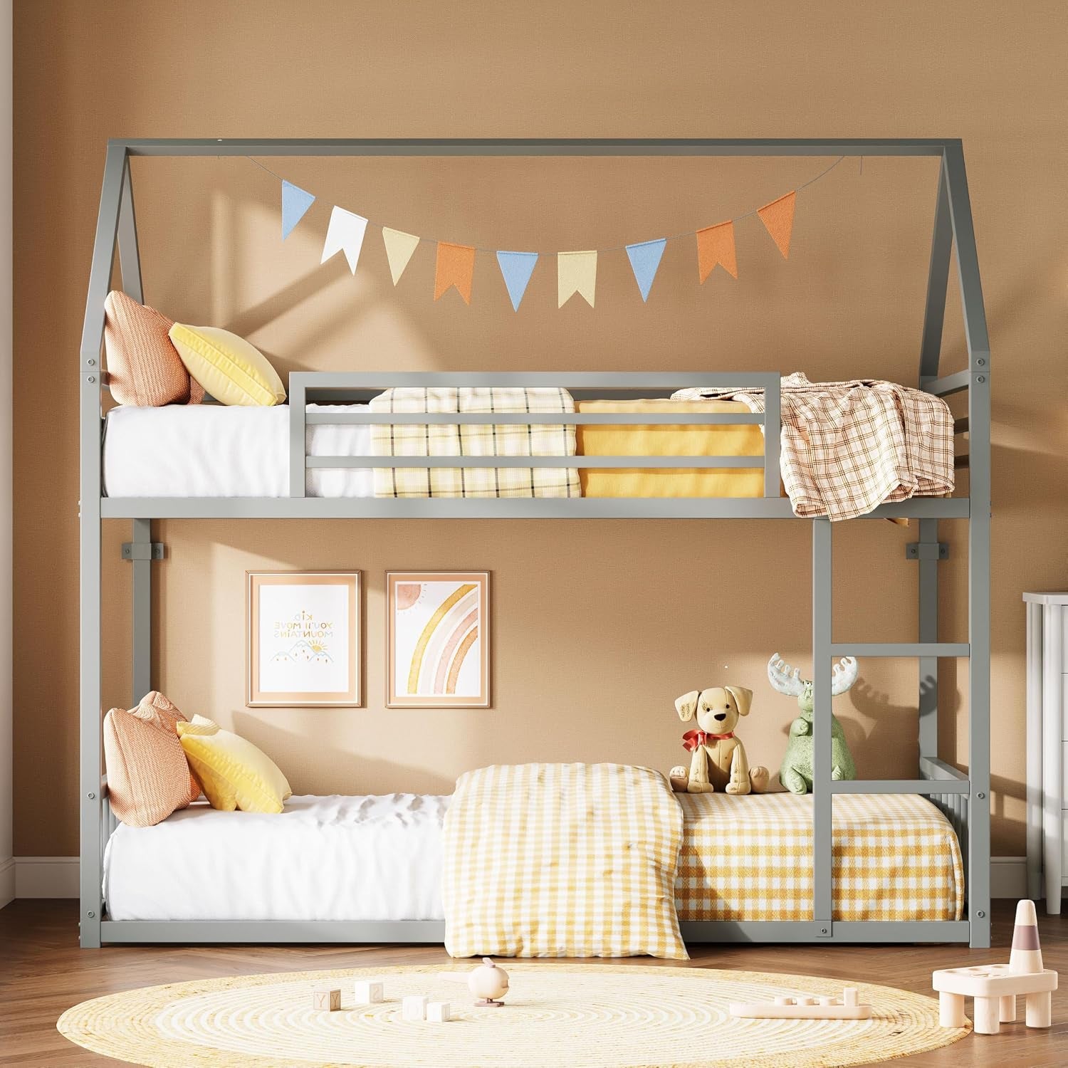 Gray twin-over-twin house-style bunk bed with ladder, yellow gingham bedding, and toys