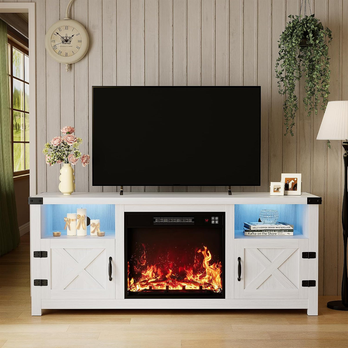 Living room view of a white-washed farmhouse TV stand with center electric fireplace and barn-style doors.
