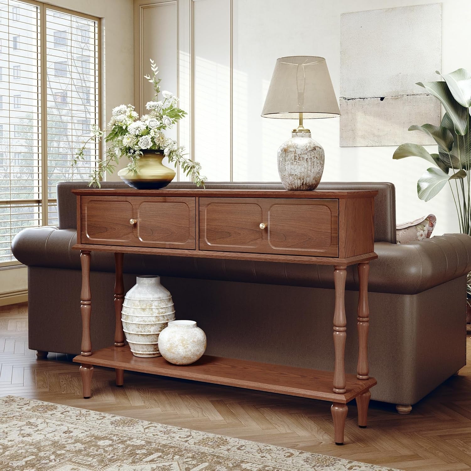 Brown console table placed behind a sofa with decorative vases on the lower shelf