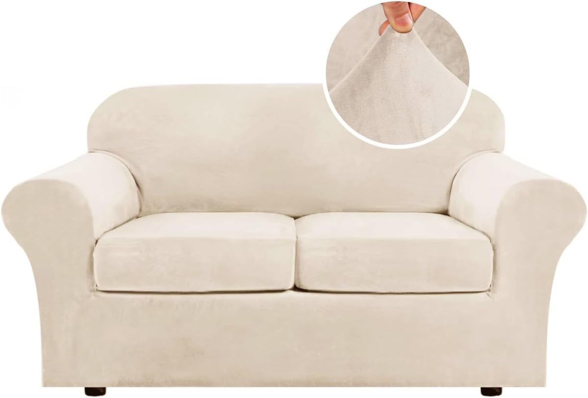 Front-facing two-seat loveseat in a soft beige velvet slipcover with a round inset showing a hand stretching the fabric