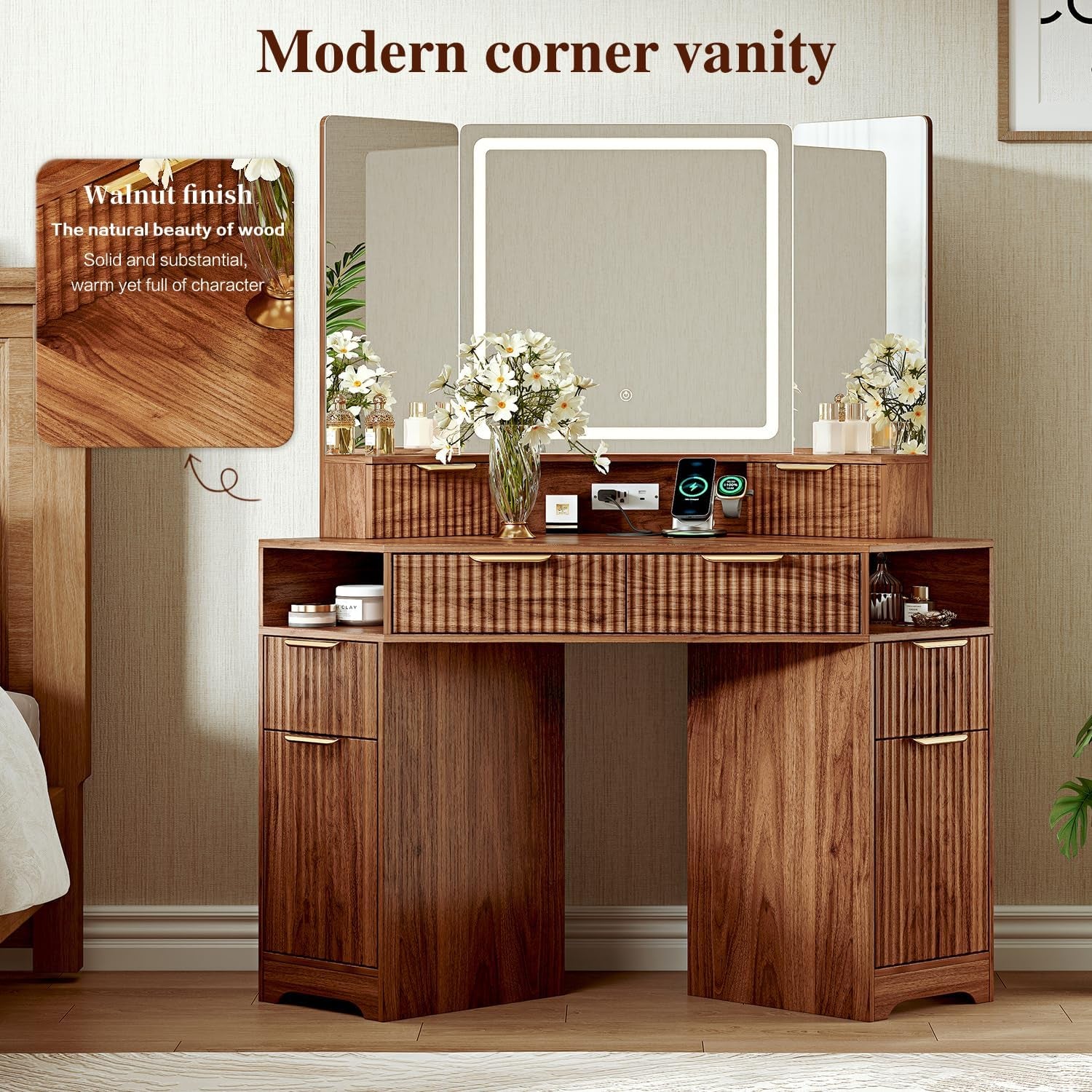 Full walnut corner vanity with fluted drawers, triple mirror and LED lighting styled with flowers.