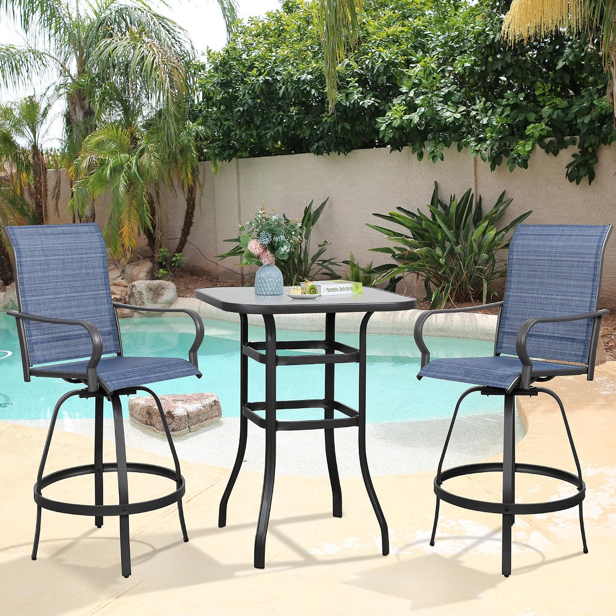 Close frontal shot of a two-chair blue bar set with a small vase on the table and pool background.