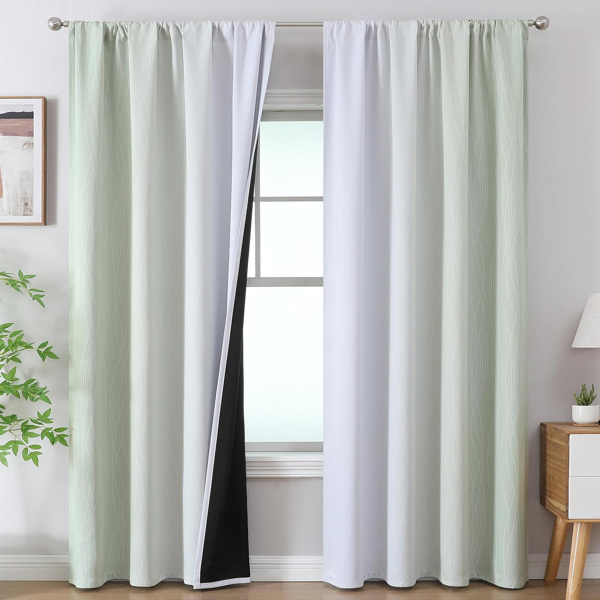 Light mint-green ombre curtains on a rod showing white inner panels and black blackout backing.