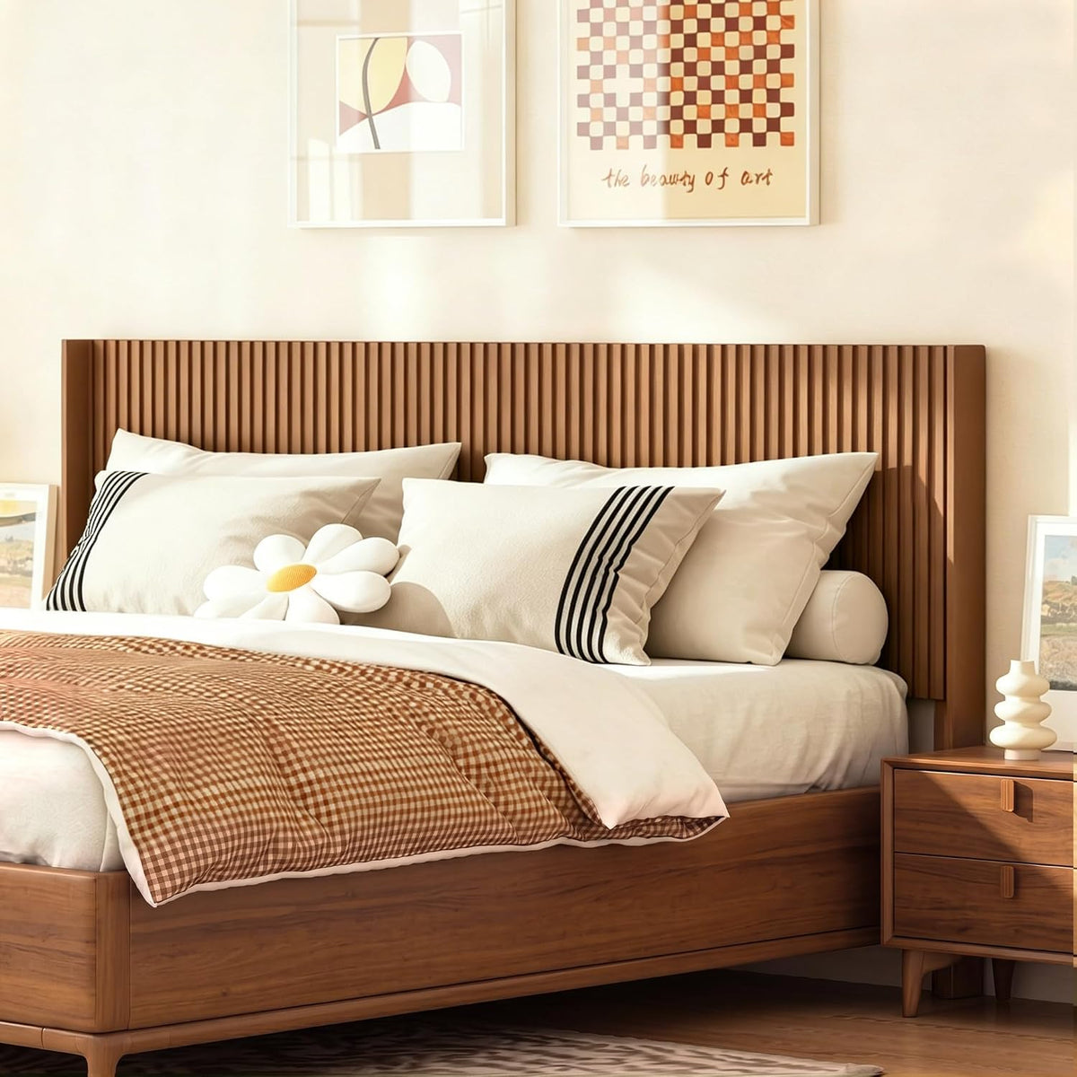 Close front view of vertical fluted headboard in warm wood finish with pillows and a nightstand at right