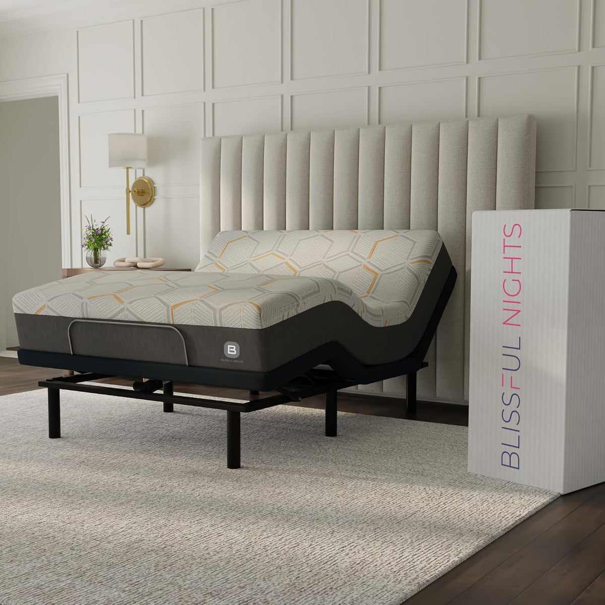 Angled bedroom view of an adjustable bed partially raised with a patterned mattress and tall upholstered headboard