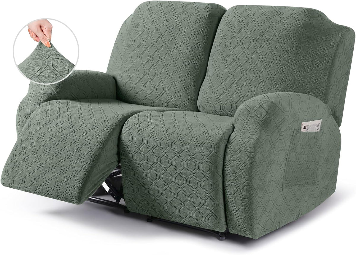 Three-seat reclining sofa in sage green slipcover with left footrest extended and inset showing hand stretching fabric.