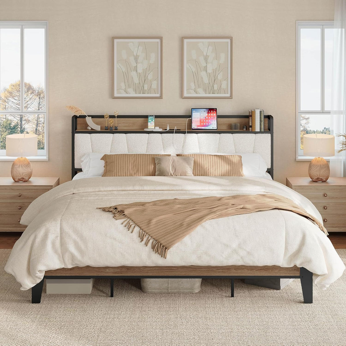 Front view of wood-and-fabric bed with light upholstered headboard shelf holding a phone and tablet, beige bedding.