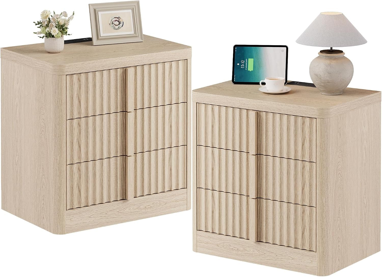 Two light oak nightstands side by side, each topped with decorative items and a charging tablet.