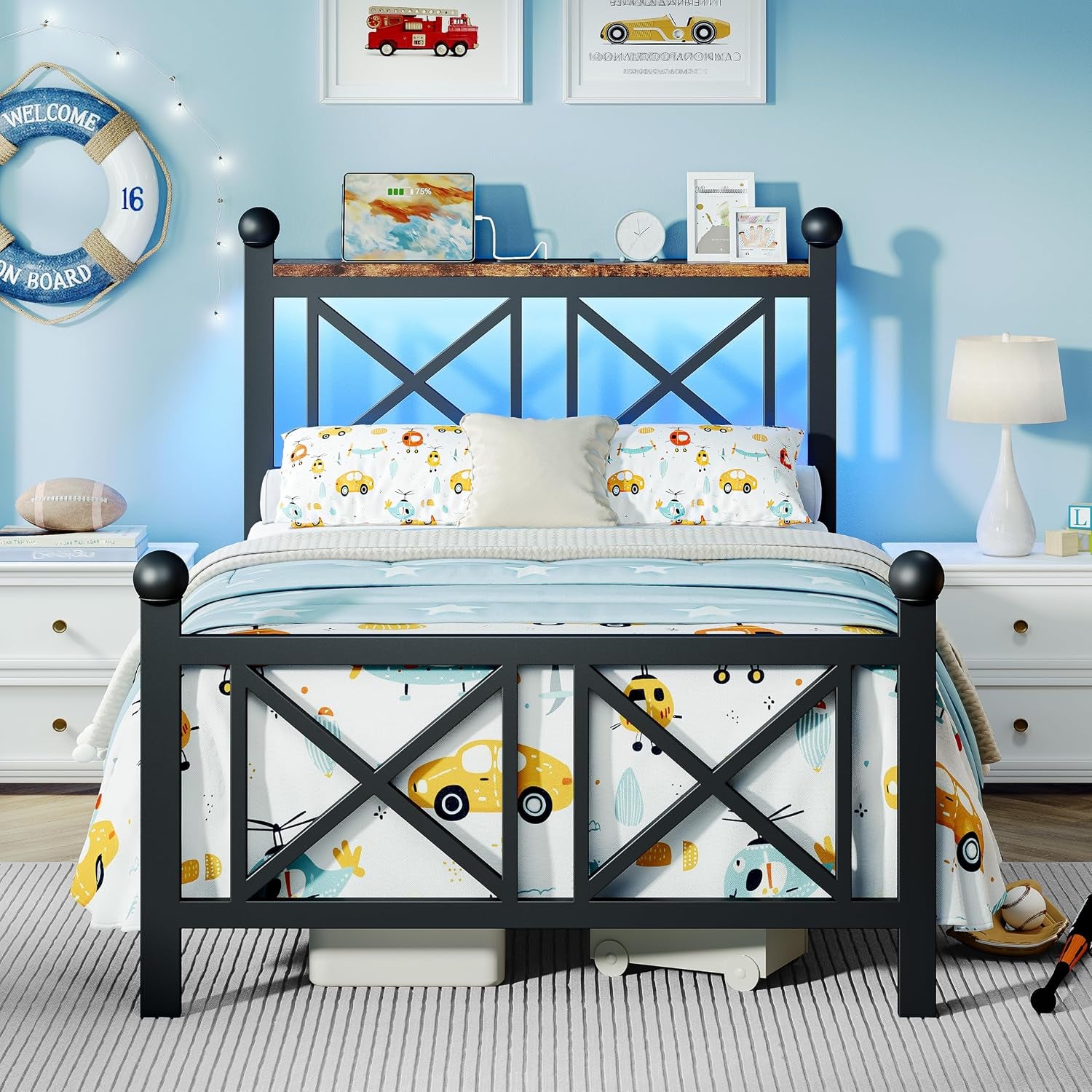 Front view of black bed with blue LED backlight and headboard shelf holding a tablet and small decor