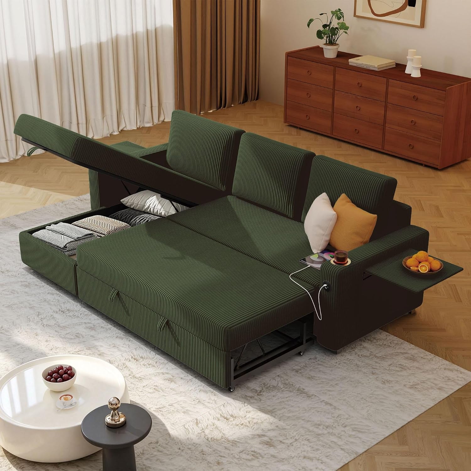 Green corduroy L-shaped sectional converted to a bed showing open under-seat storage and USB cable