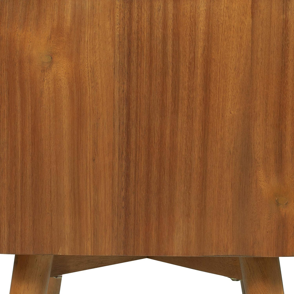 Close-up of warm wood grain on the nightstand's side and the curved lower edge above short rounded legs