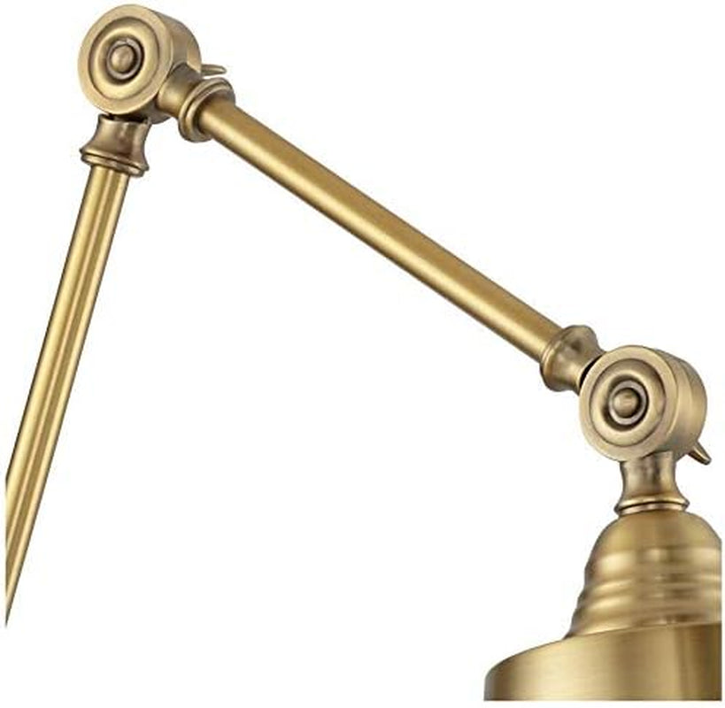Close-up of the swing-arm joint and swivel hardware in antique brass showing adjustable connector detail