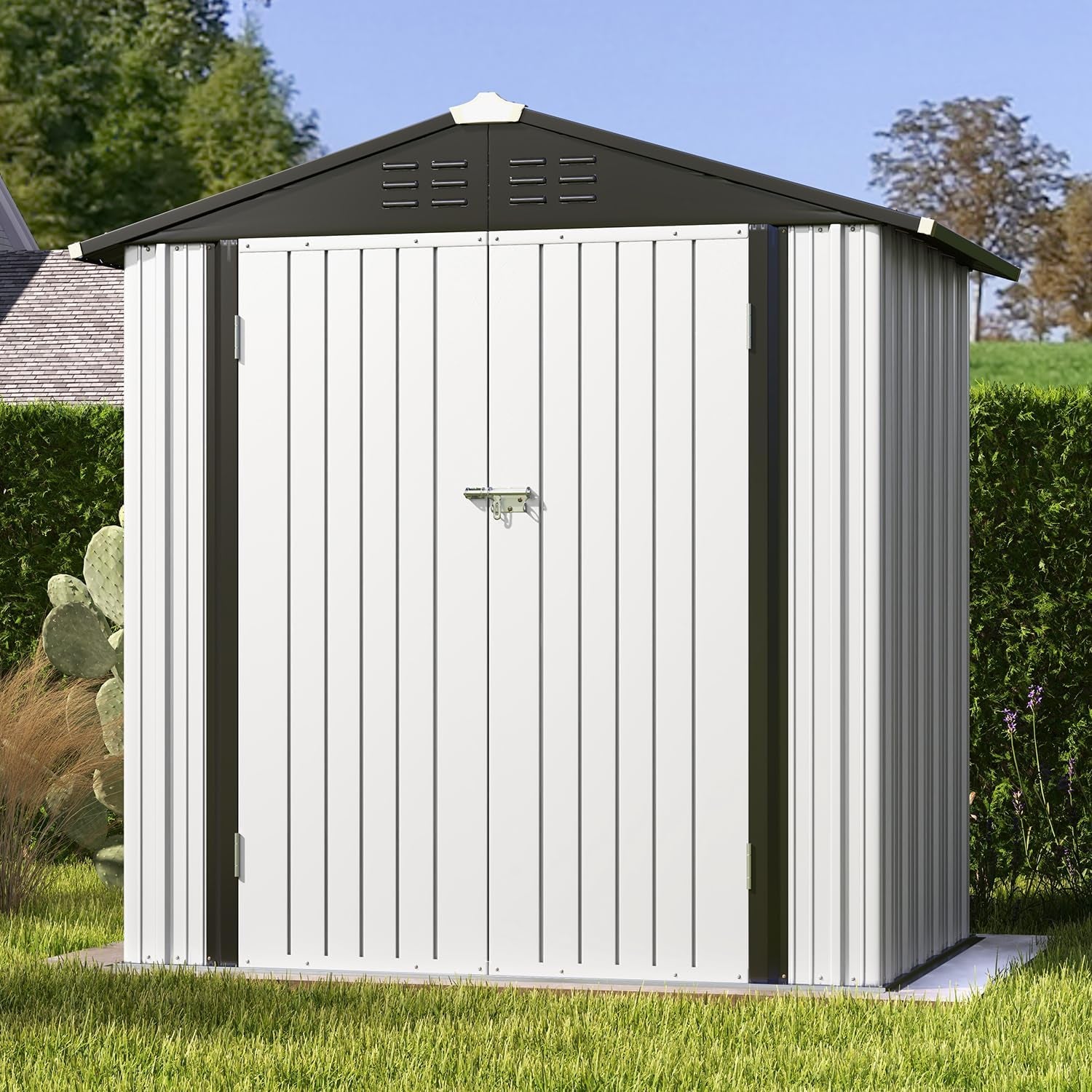 Close frontal view of a white metal shed door with dark roof trim and a latch in a grassy backyard.