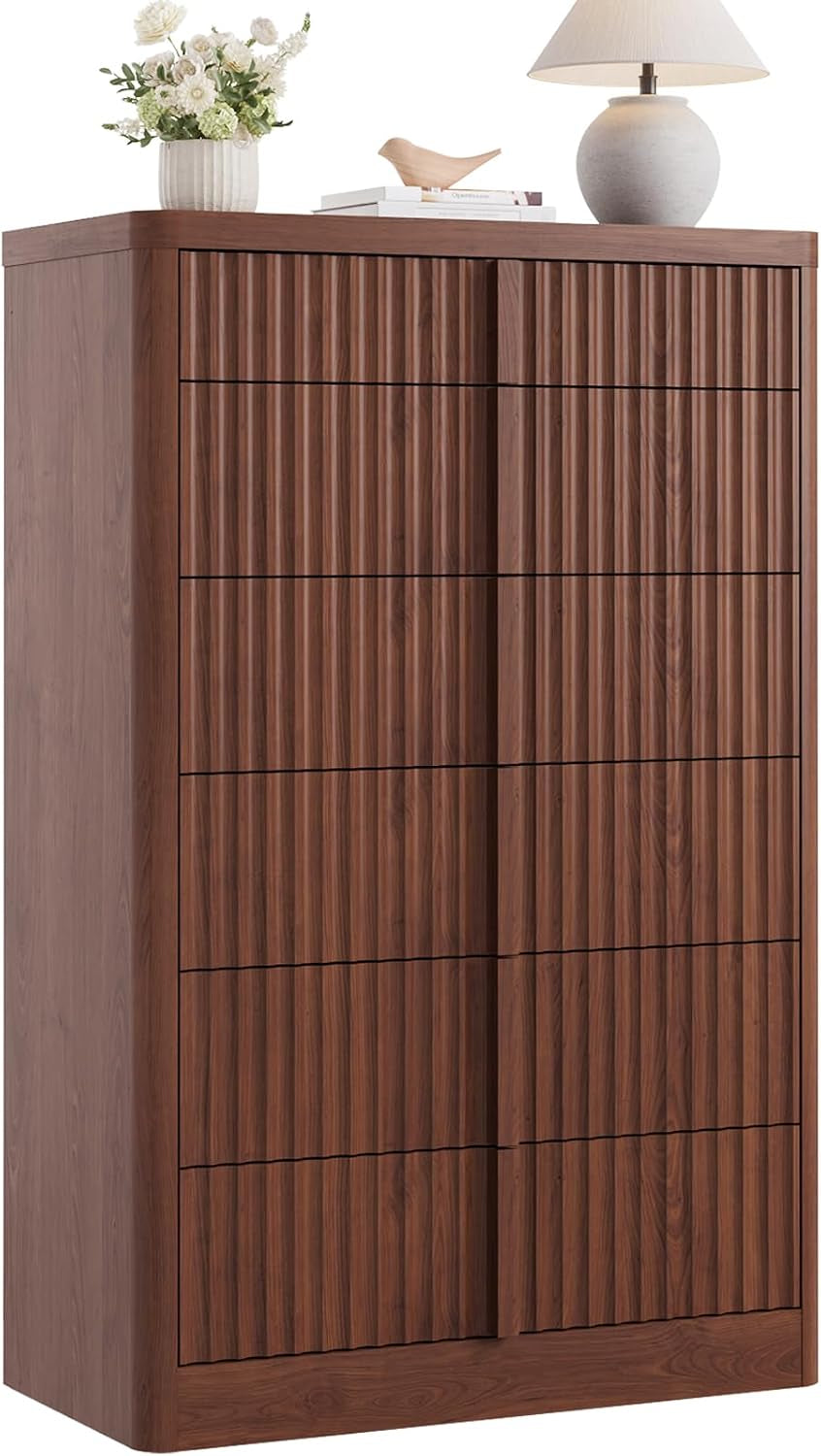 Close side view of a tall fluted dresser in medium walnut, showing vertical grooved drawer fronts and rounded edges.