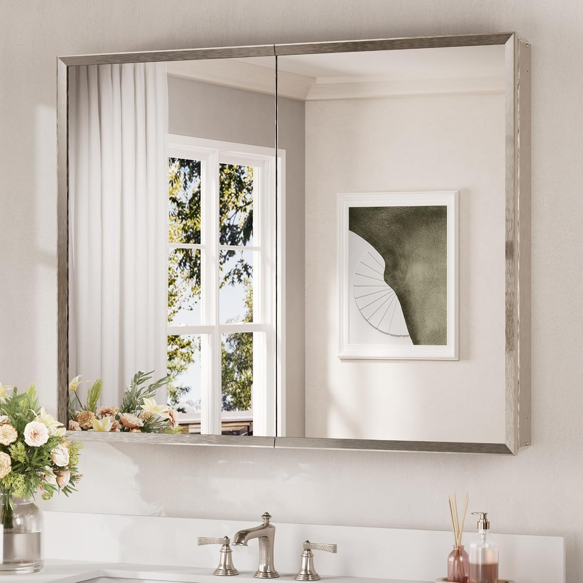 Wide mirrored two-door medicine cabinet with brushed nickel frame mounted above a vanity.