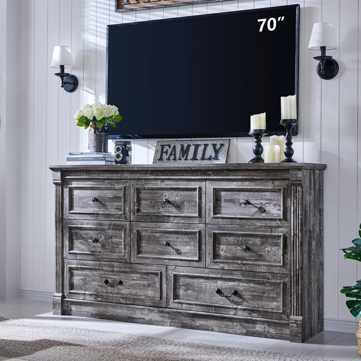 Weathered gray seven-drawer dresser with decorative drawer panels and column accents, styled under a mounted TV.