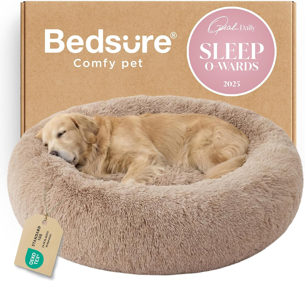 Three-quarter view of a tan faux-fur donut bed with a golden retriever curled up asleep against a cardboard box.