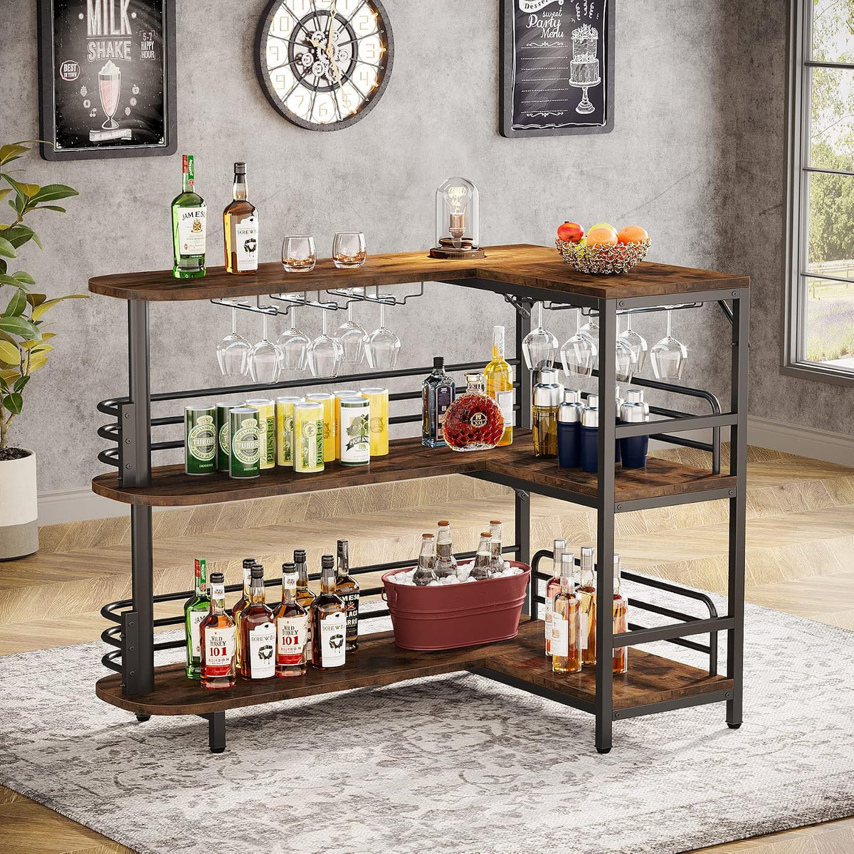 Angled corner view of brown home bar with stemware rack and bottles on middle and lower shelves in a bright room