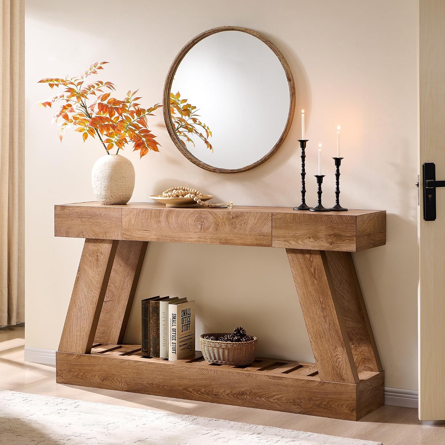 Light brown wood-look console table with angled legs and a slatted lower shelf in an entryway.