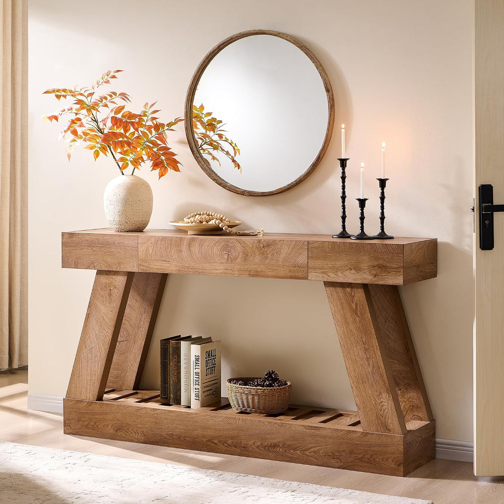 Light brown wood-look console table with angled legs and a slatted lower shelf in an entryway.