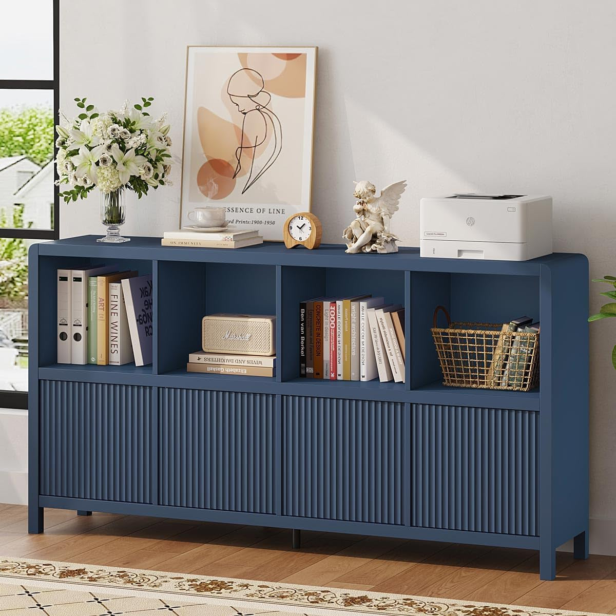 Same low eight-cube storage cabinet in blue with open cubbies holding books, basket and decor on top