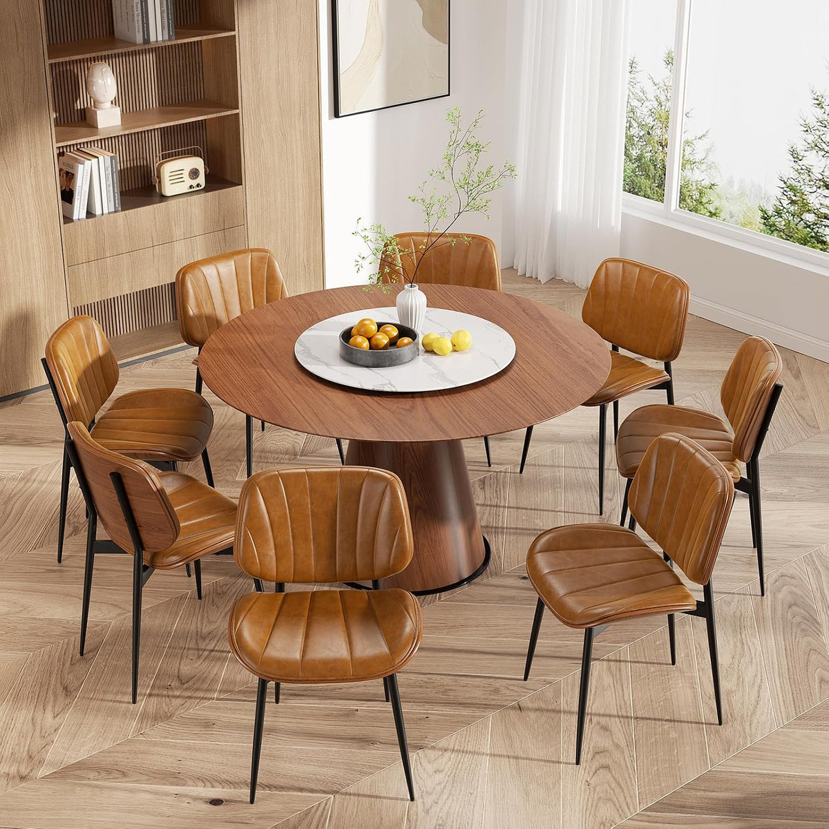Round walnut dining table surrounded by eight tan faux-leather chairs with black legs.