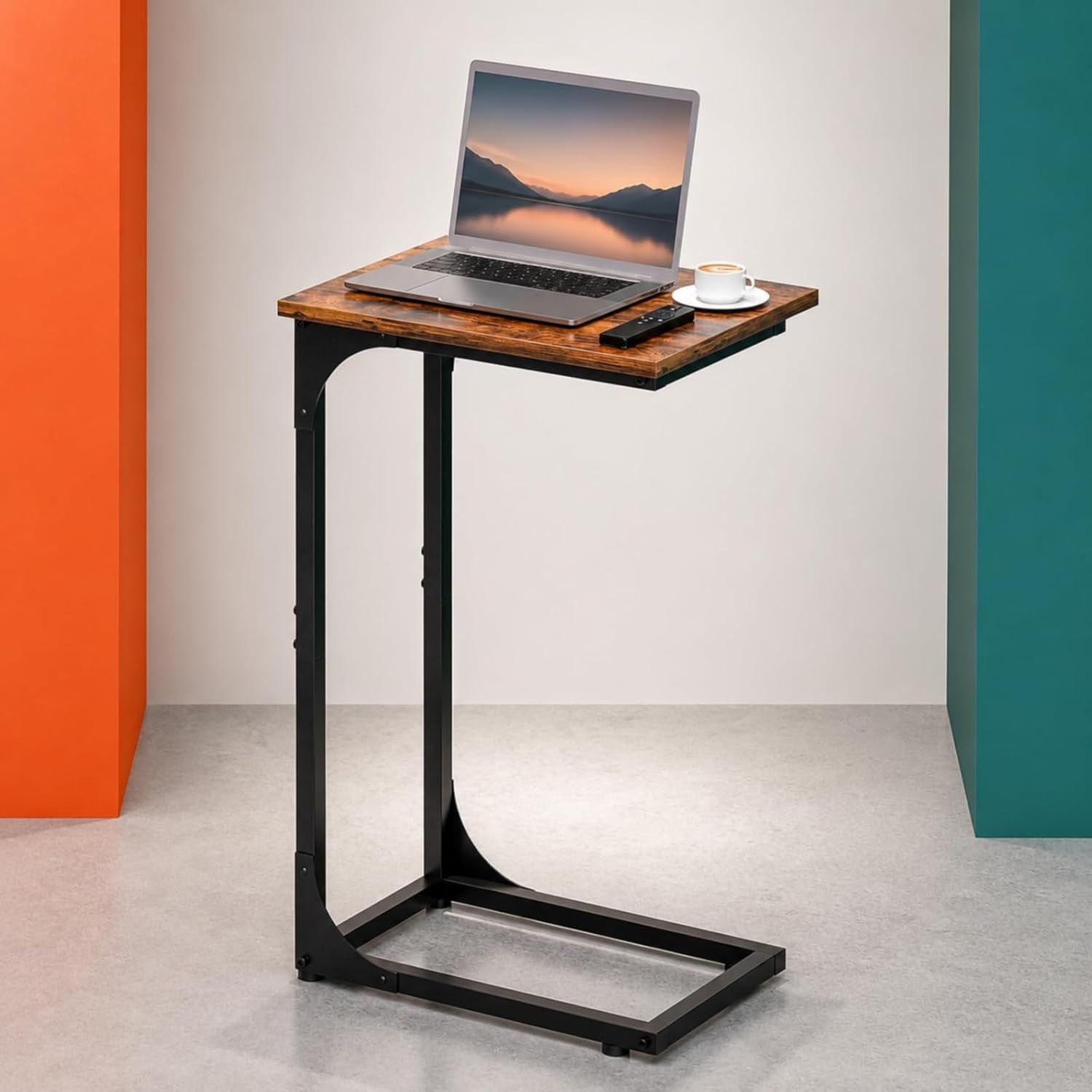 C-shaped end table with rustic brown top and black steel frame angled front view with laptop and coffee cup