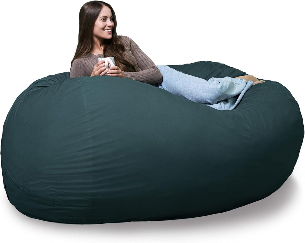 Woman reclining with a mug on an oversized dark teal bean bag lounger