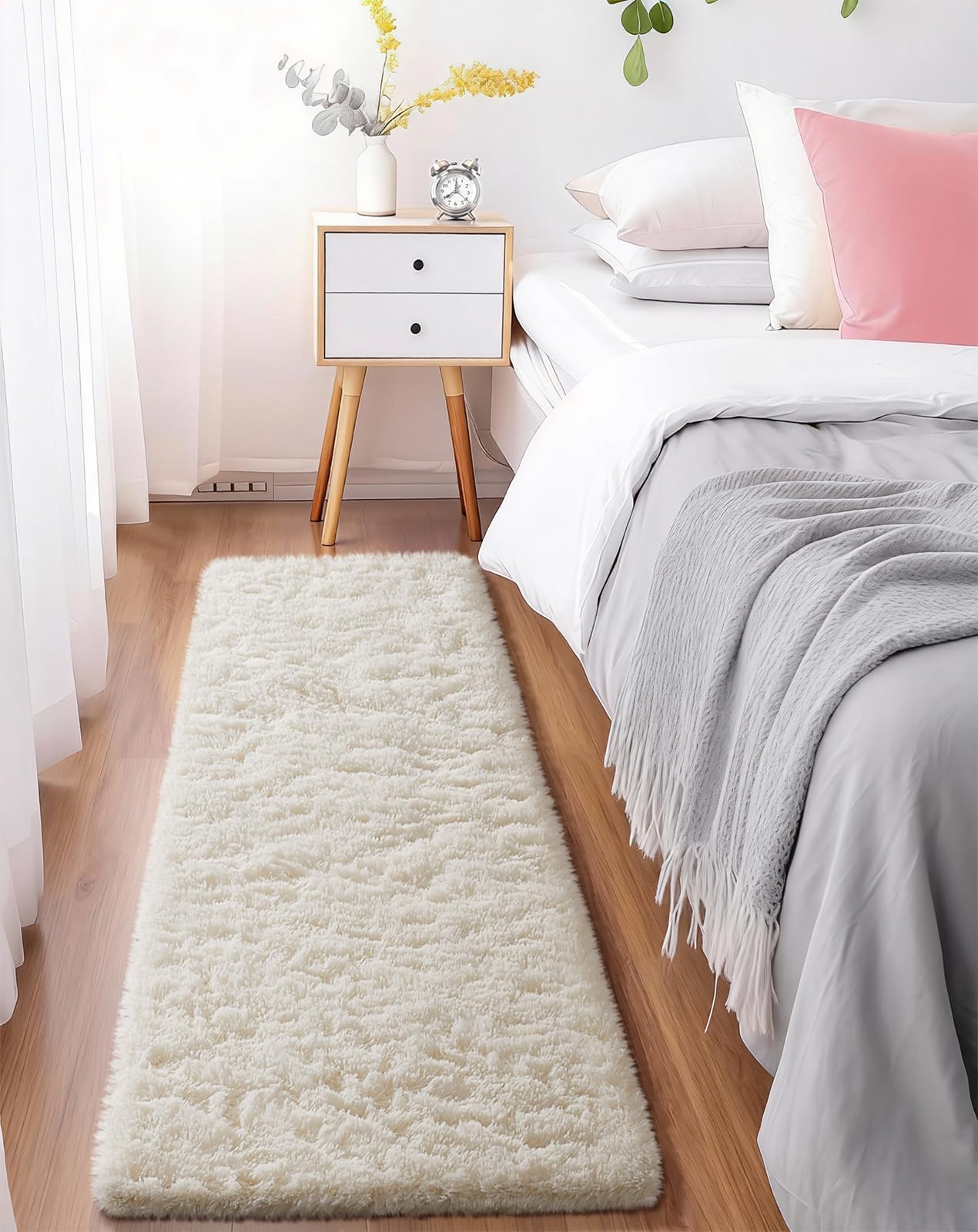 Bedroom corner with a long cream shag runner beside a bed and wooden nightstand