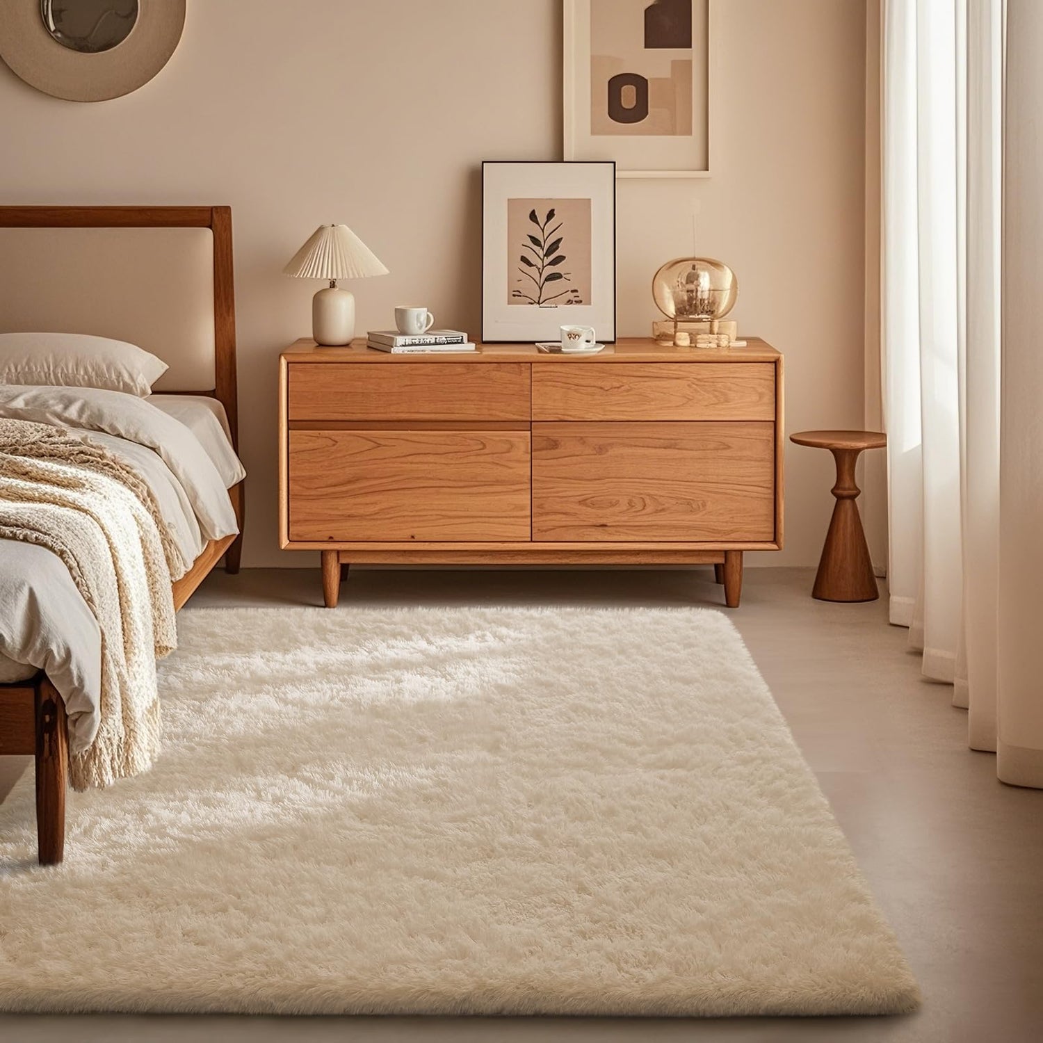 Bedroom corner with plush cream area rug underfoot beside a wooden bed frame and low dresser.