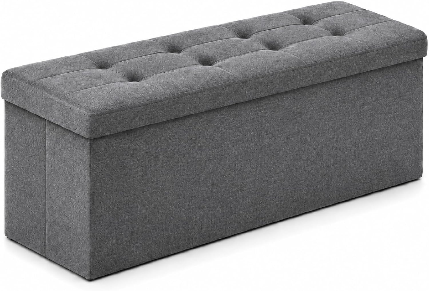 Dark grey tufted storage ottoman angled to show the padded lid and squared base.