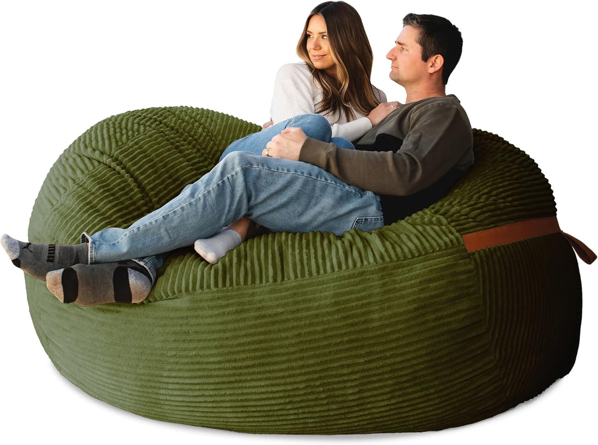 Couple cuddled on a large olive-green ribbed lounger shown from a low side angle