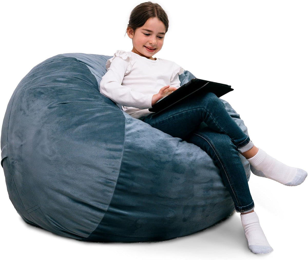Child sitting on a large slate-blue corded plush bean bag using a tablet