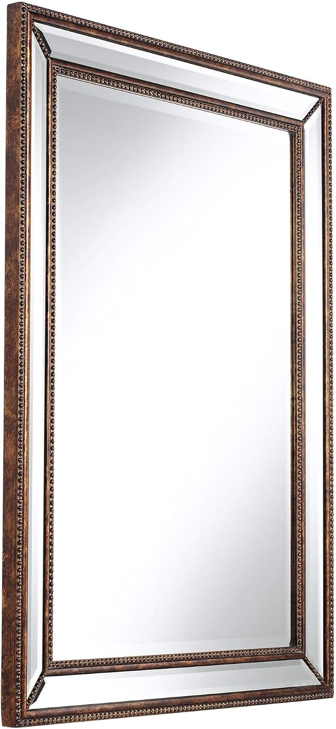 Angled side view of the mirror showing its depth, mirrored border and antique mottled bronze frame