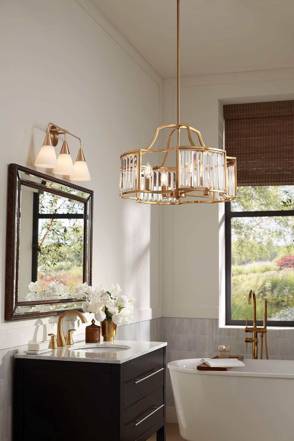 Mirror mounted above a bathroom vanity showing reflective glass and beaded bronze frame details in a styled setting