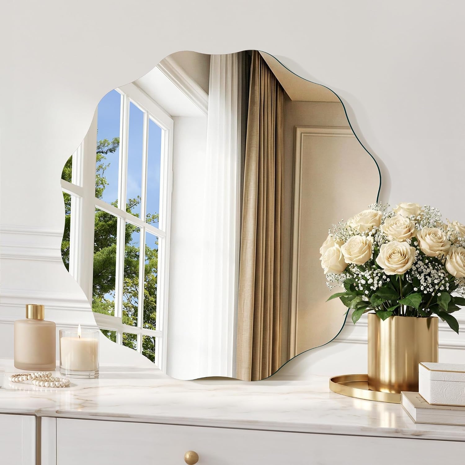 Partial mirror showing window mullions and beige drapery, with a bouquet in a gold planter at the right edge.