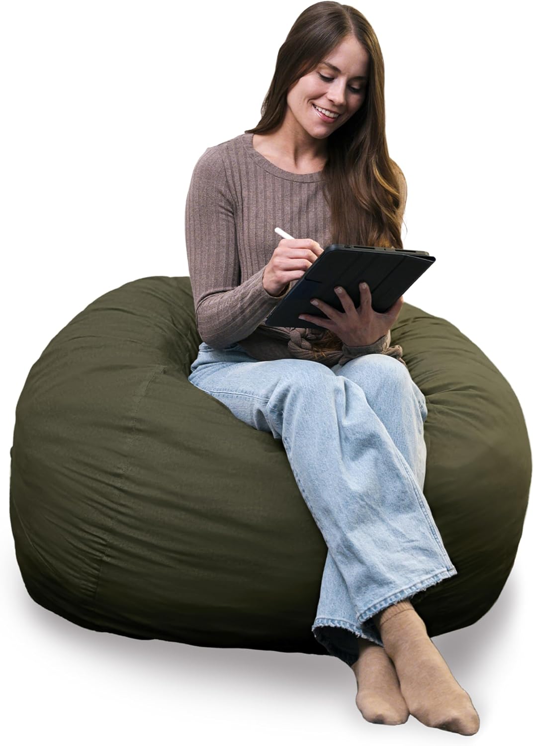 Woman seated on a deep olive-green lounger using a tablet, legs crossed and feet resting on the front.