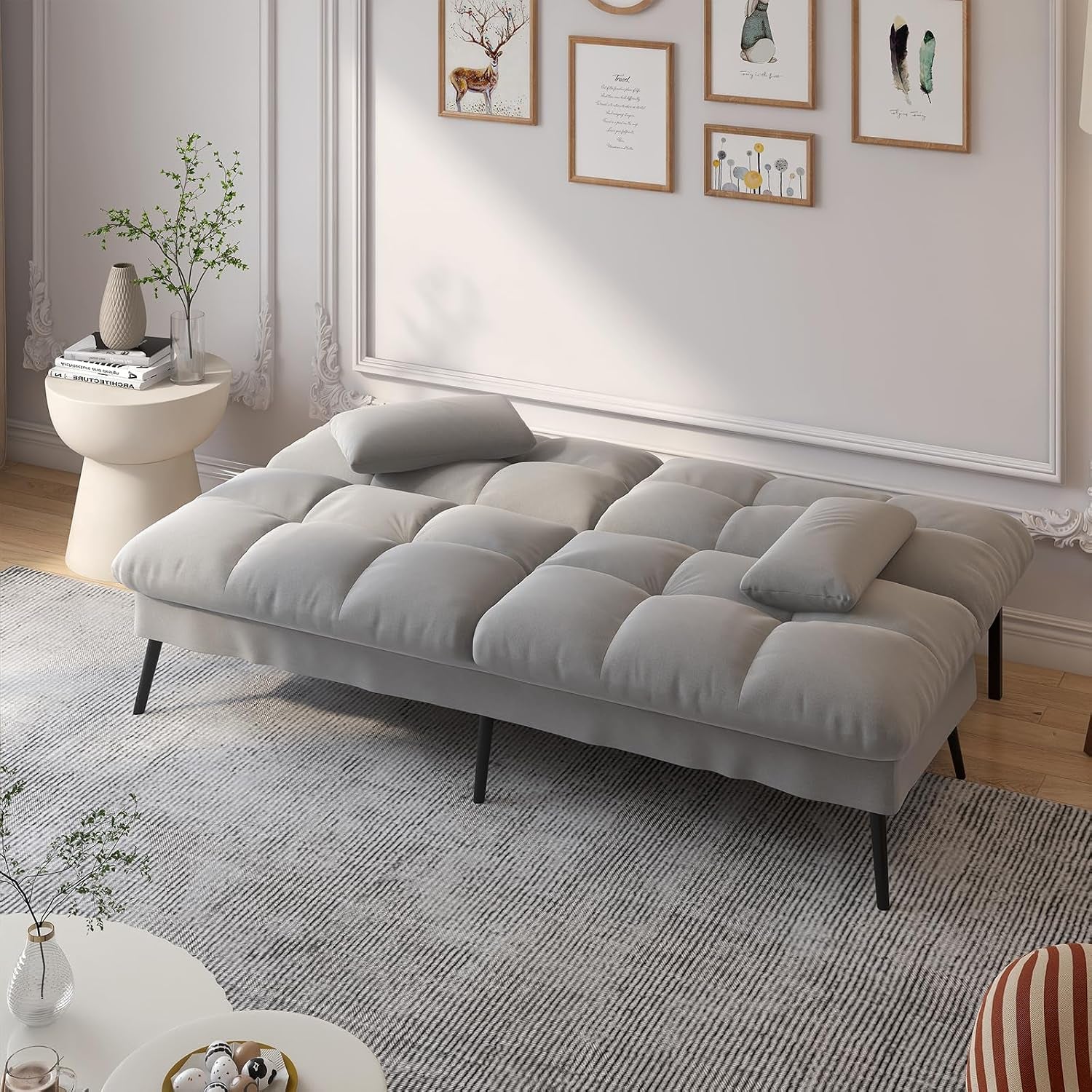 Fully extended futon sofa bed in grey fabric shown from above in a living room scene without backrests raised